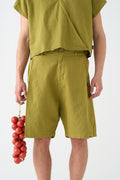Pistachio-colored wide Bermuda shorts